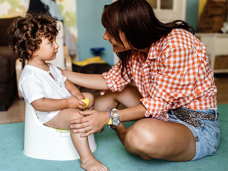 Toddler Girl On A Potty In The Living Room High-Res Stock Photo