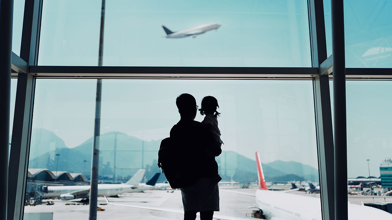 silhouette-father-daughter-looking-out-window-airport-airplane-flying