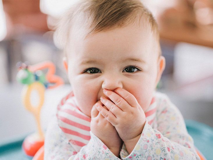 Newborn putting hands in 2024 mouth