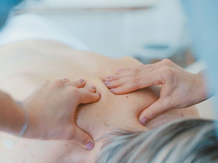 Massage relax studio. Woman having her neck massaged by a physiotherapist.  Massage therapist massaging neck muscles. Body care. Beautiful young girl  relaxing with hand massage at beauty body spa. Stock Photo