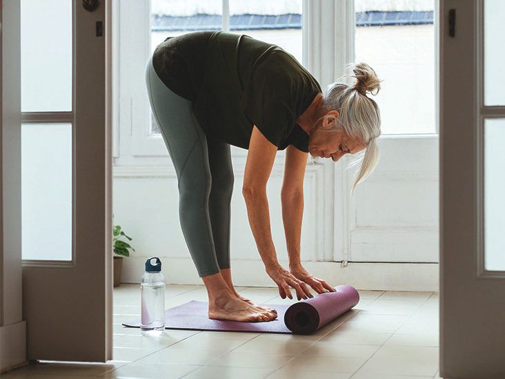 https://media.post.rvohealth.io/wp-content/uploads/2020/08/senior-woman-stretching-home-yoga-732x549-thumbnail-732x549.jpg