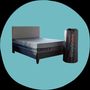Side view of Layla Hybrid Mattress on bed frame with mattress bag