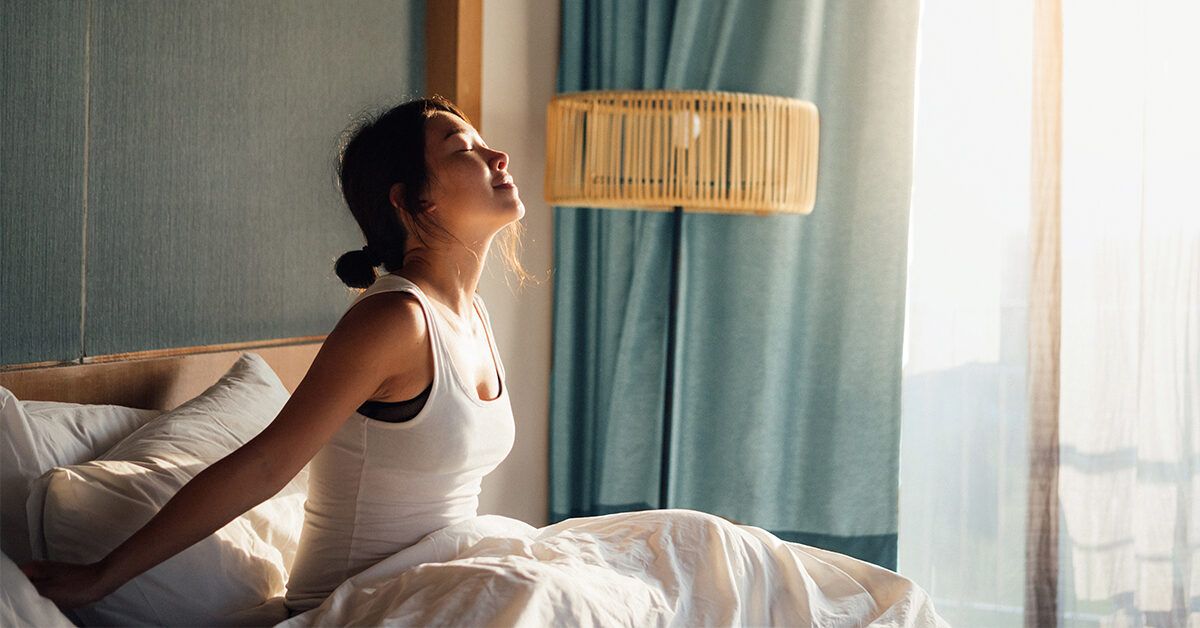 https://media.post.rvohealth.io/wp-content/uploads/2021/01/morning-bed-stretching-stretch-1200x628-facebook-1200x628.jpg