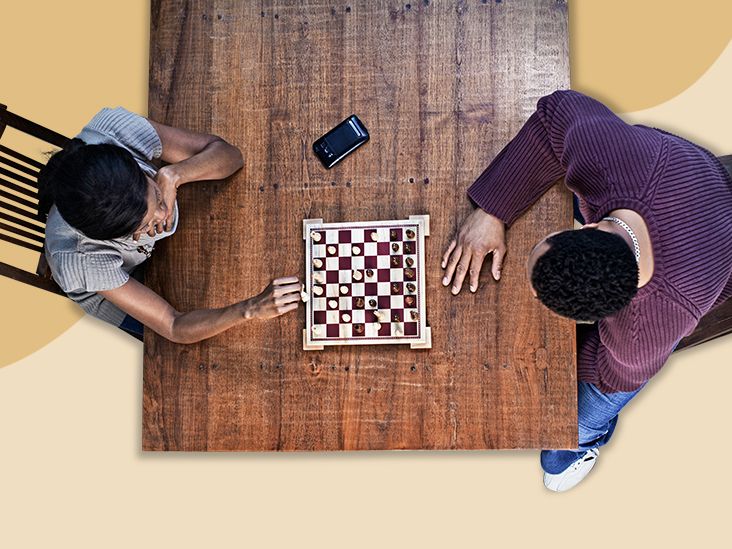 Grown men play chess using a watch to control time