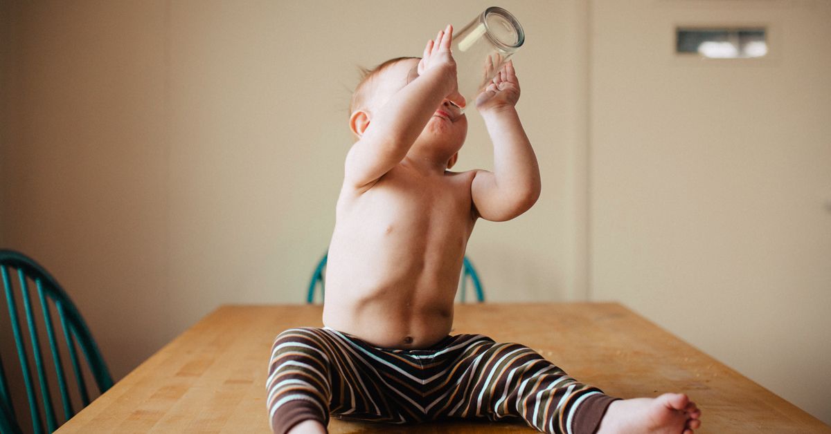 https://media.post.rvohealth.io/wp-content/uploads/2021/05/toddler-drinkng-out-of-glass-cup-1200x628-facebook-1.jpg