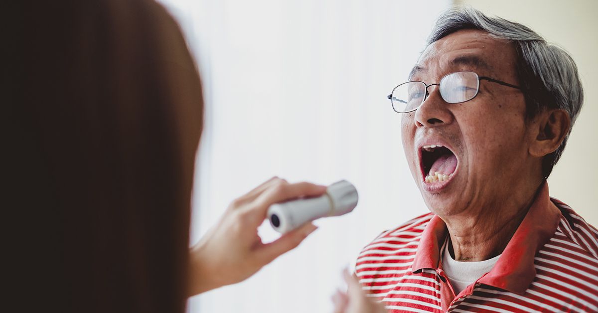 Older Asian Man Patient Tongue Examined Doctor 1200x628 Facebook 