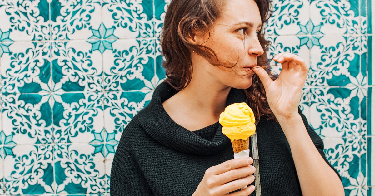 https://media.post.rvohealth.io/wp-content/uploads/2021/07/woman-licking-finger-while-eating-ice-cream-1200x628-facebook.jpg