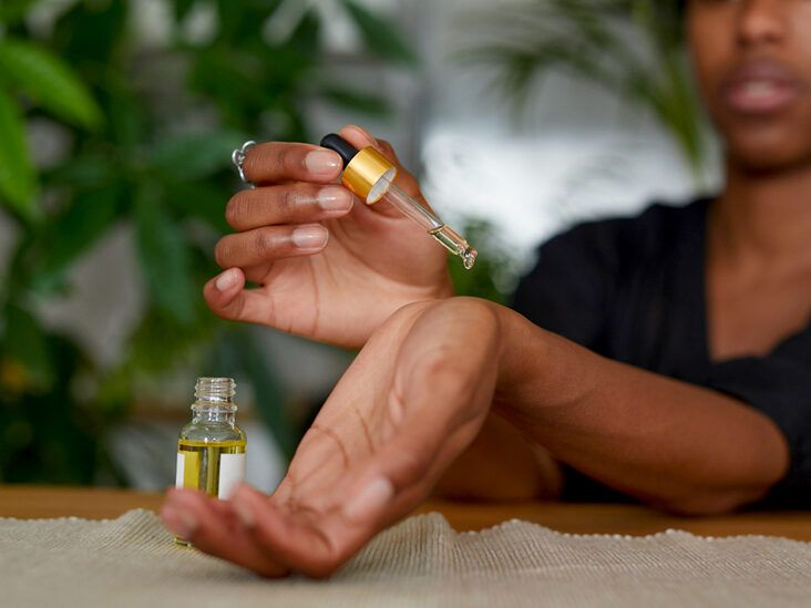 African American Woman putting essential oil on her arm 732X549 thumbnail
