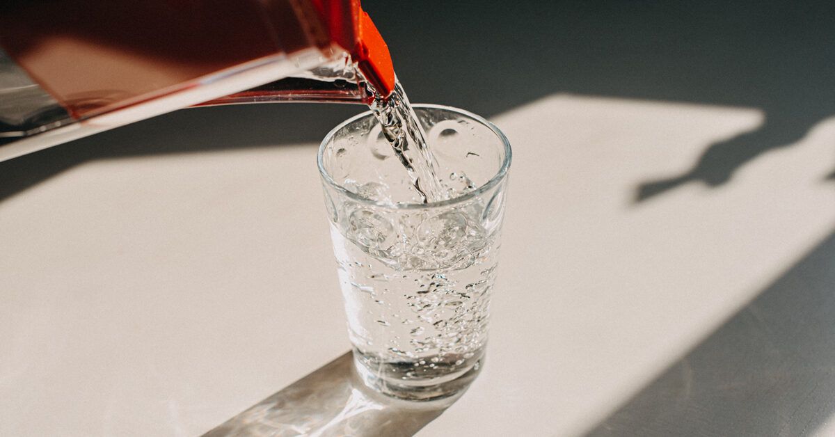https://media.post.rvohealth.io/wp-content/uploads/2021/08/pouring-water-into-glass-1200x628-facebook-1200x628.jpg