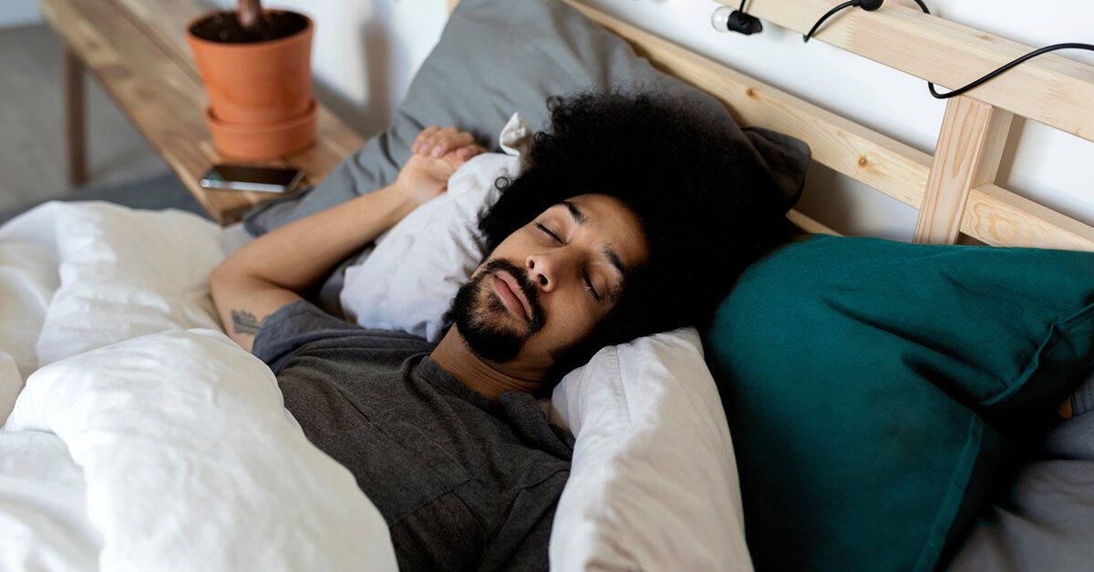 https://media.post.rvohealth.io/wp-content/uploads/2021/12/male-sleeping-on-back-in-bed-1200-628-facebook-1200x628.jpg