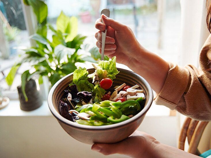 https://media.post.rvohealth.io/wp-content/uploads/2022/05/female-eating-salad-in-bowl-732-549-feature-thumb-732x549.jpg