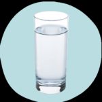 a glass of water against a light blue background