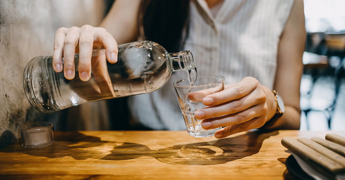 https://media.post.rvohealth.io/wp-content/uploads/2023/02/woman-pouring-water-into-glass-at-restaurant-1200x628-facebook-1200x628.jpg