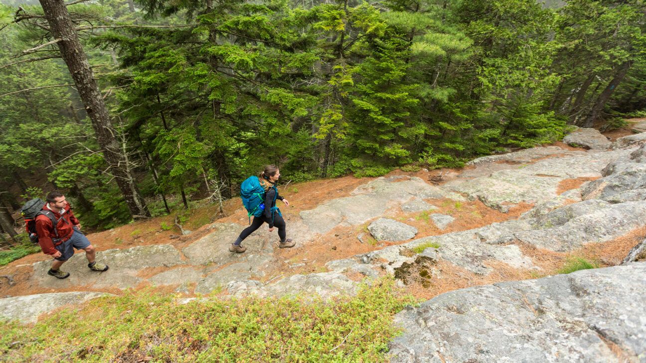 Two people hiking outside.