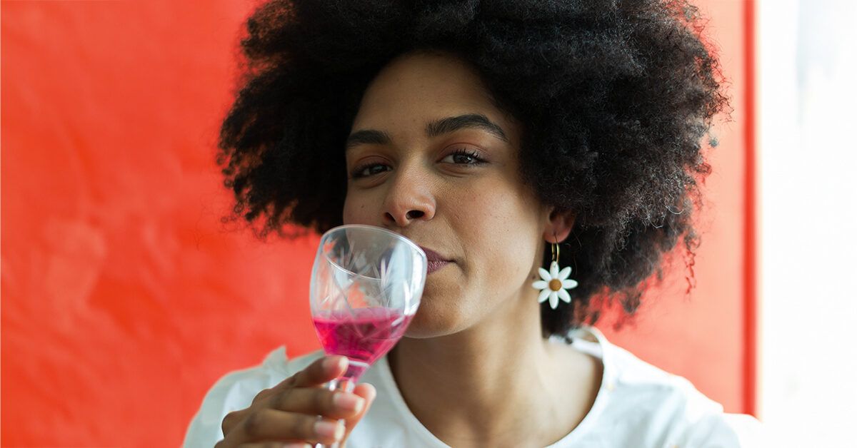 https://media.post.rvohealth.io/wp-content/uploads/2023/08/portrait-woman-drinking-wine-orange-wall-background-1200x628-facebook-1200x628.jpg