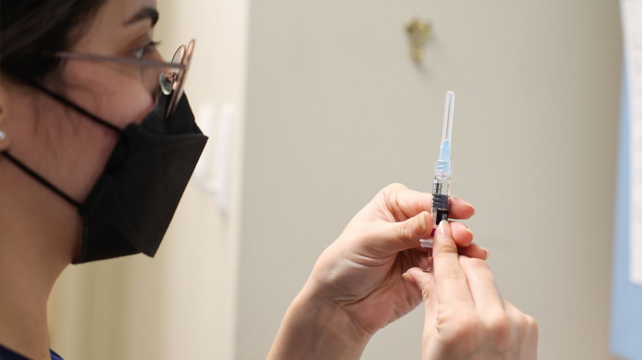 A woman holding a syringe.