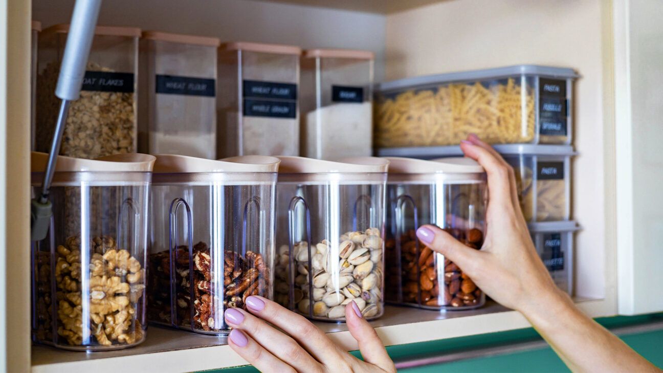 A shelf of containers with nuts is seen.