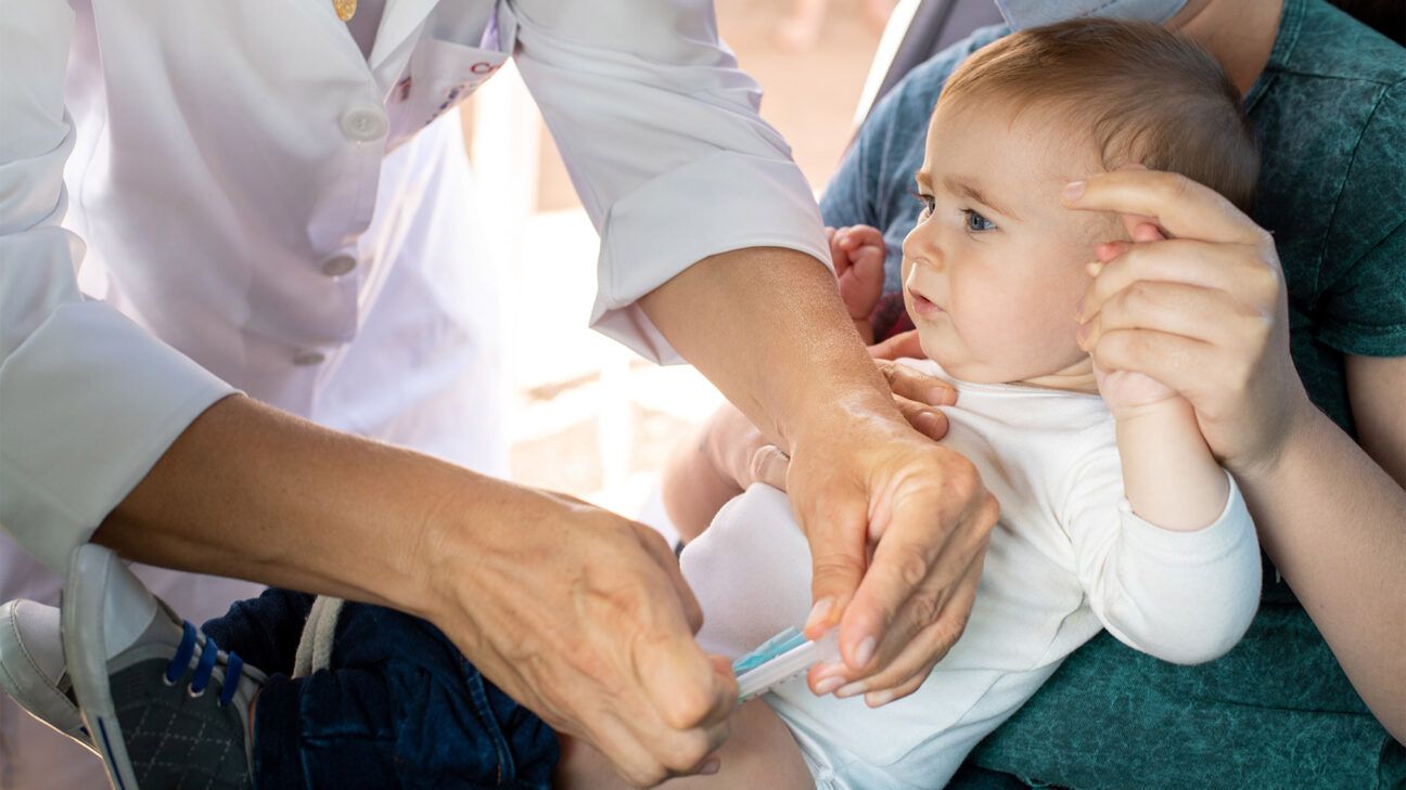 An infant gets a vaccination.