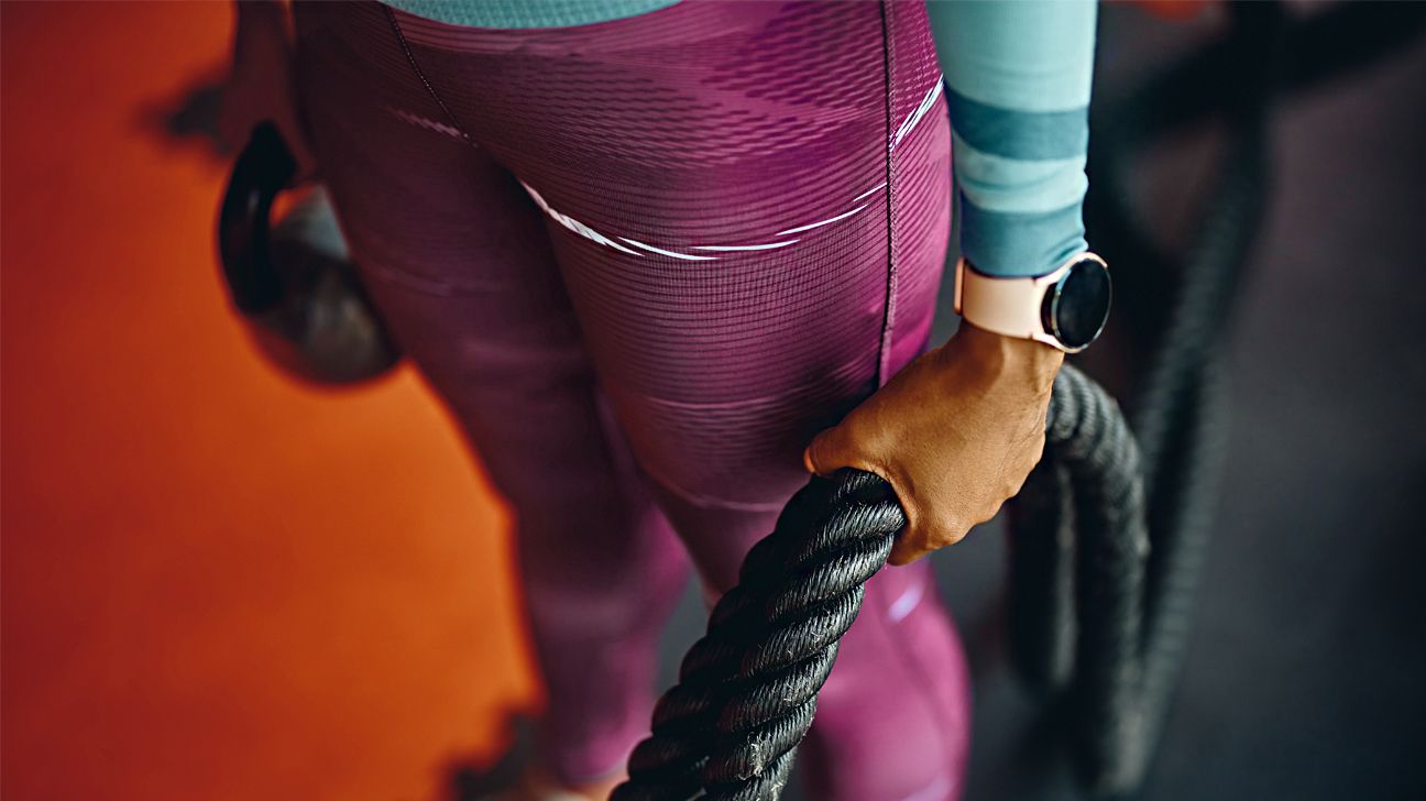 A person holding workout equipment.