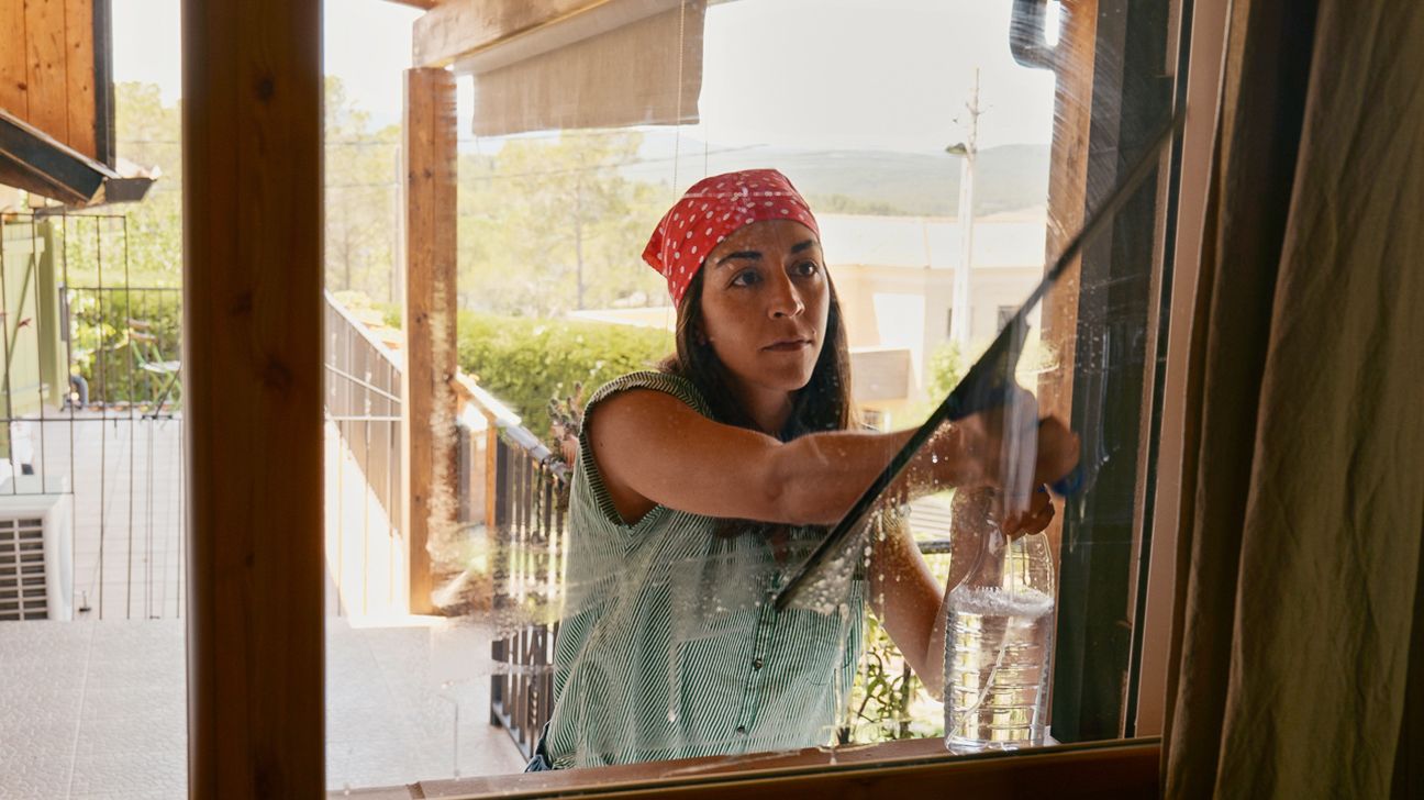 A woman cleaning a window.
