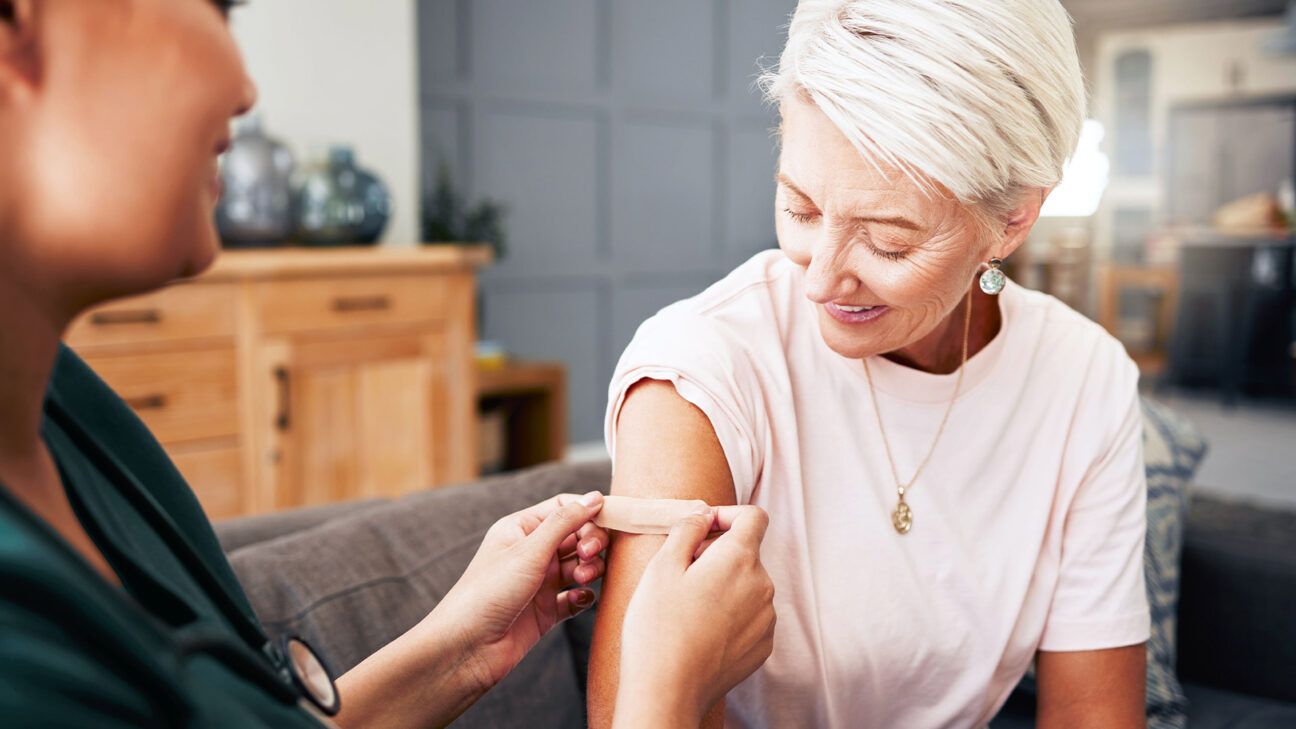 A woman gets a vaccine.