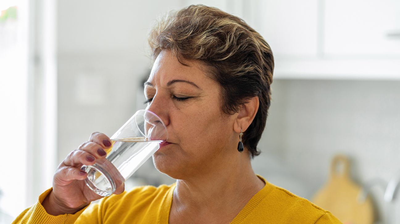 A woman drinking water.