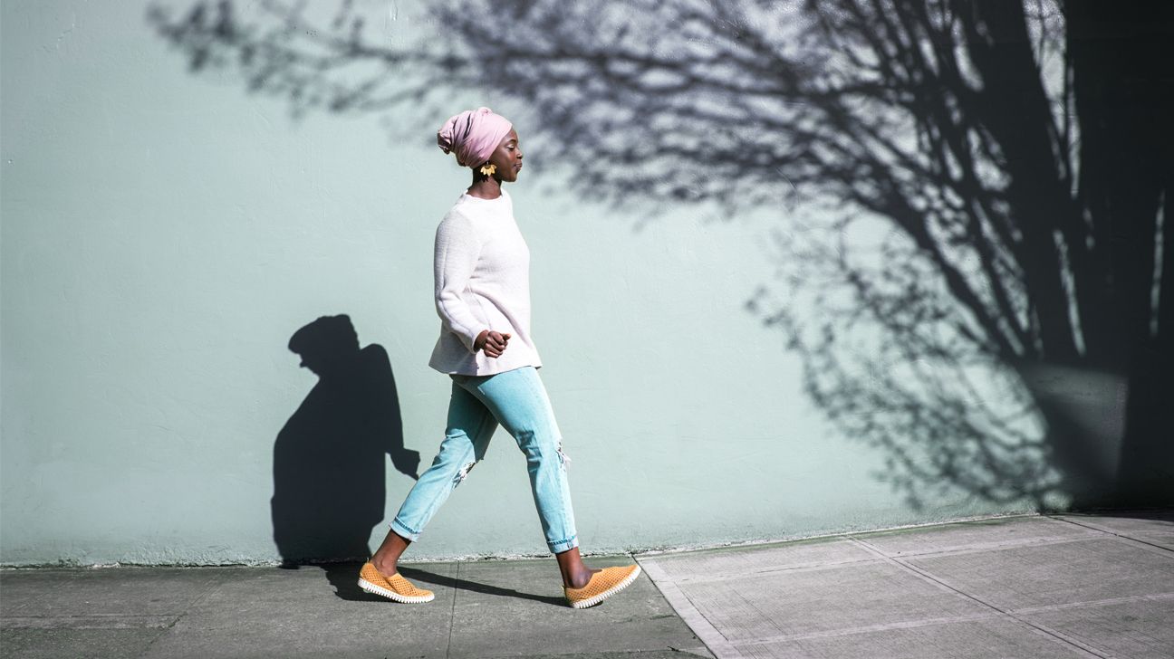 Woman walking on a sidewalk.