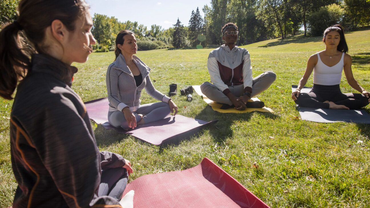 people in an outdoor meditation class