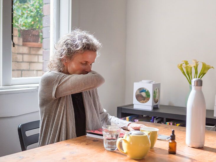 Middle aged woman coughing at home thumbnail