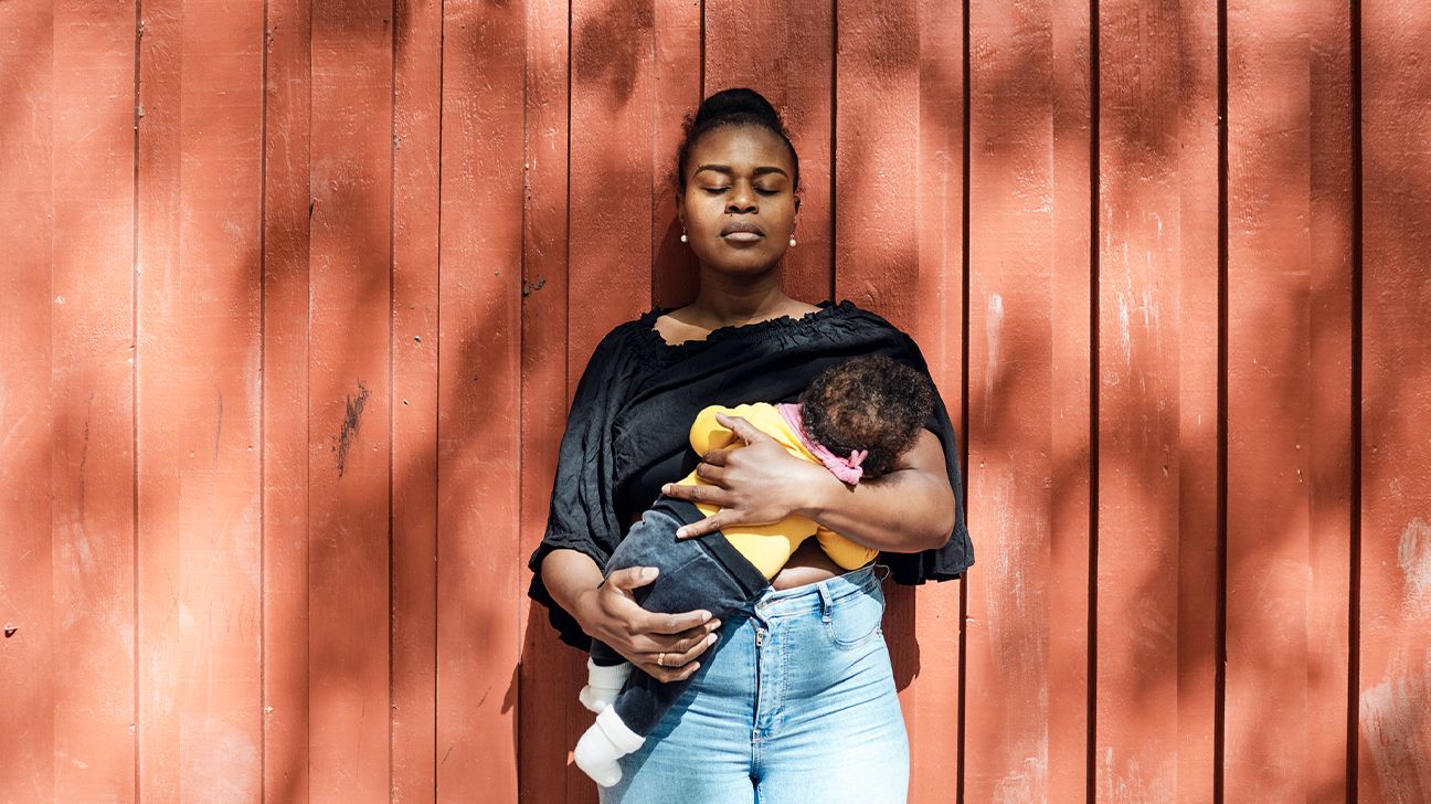 https://media.post.rvohealth.io/wp-content/uploads/2023/10/Woman-with-eyes-closed-breastfeeding-toddler-daughter-in-front-of-wall-on-sunny-day-header.jpg