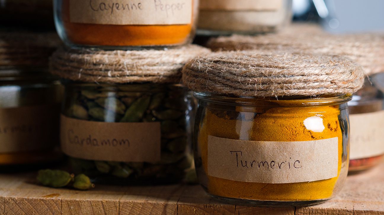 Large jars of spices: cardamom and turmeric