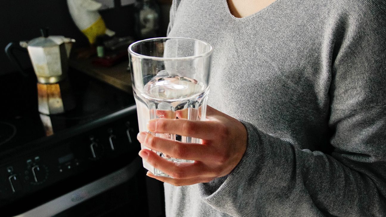 person holding a glass of water