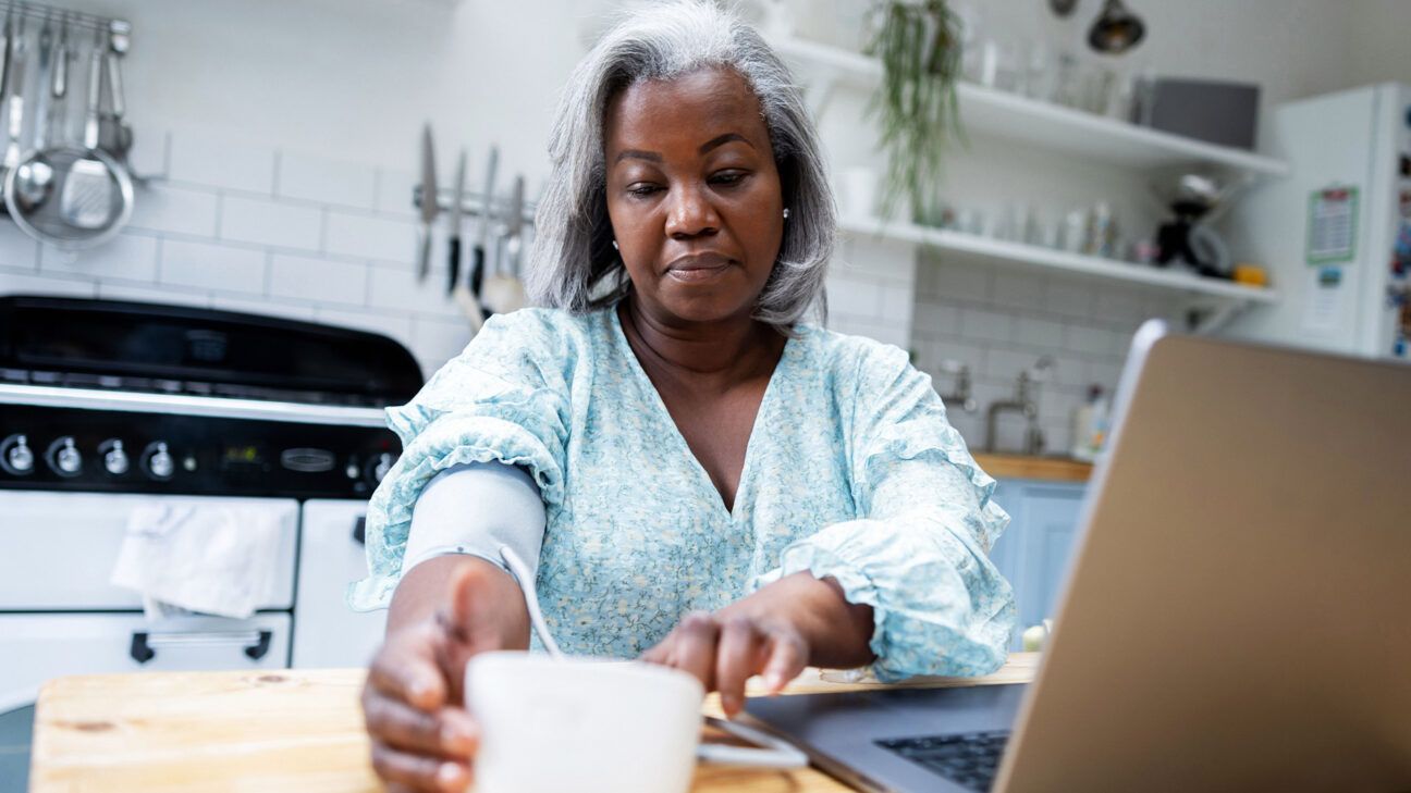 A woman checking her blood pressure.