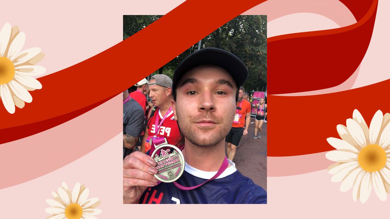 Callum Lea holding a race medal.