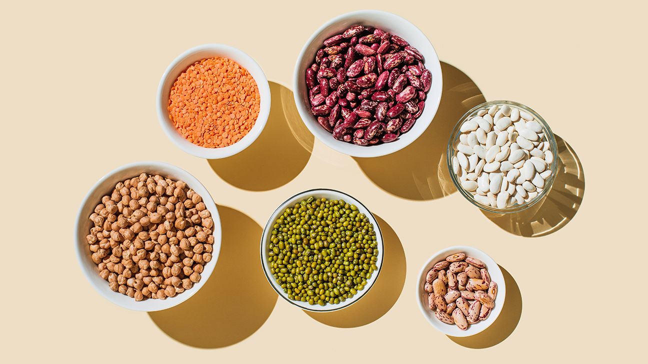 Several bowls of high fiber foods such as beans and lentils.