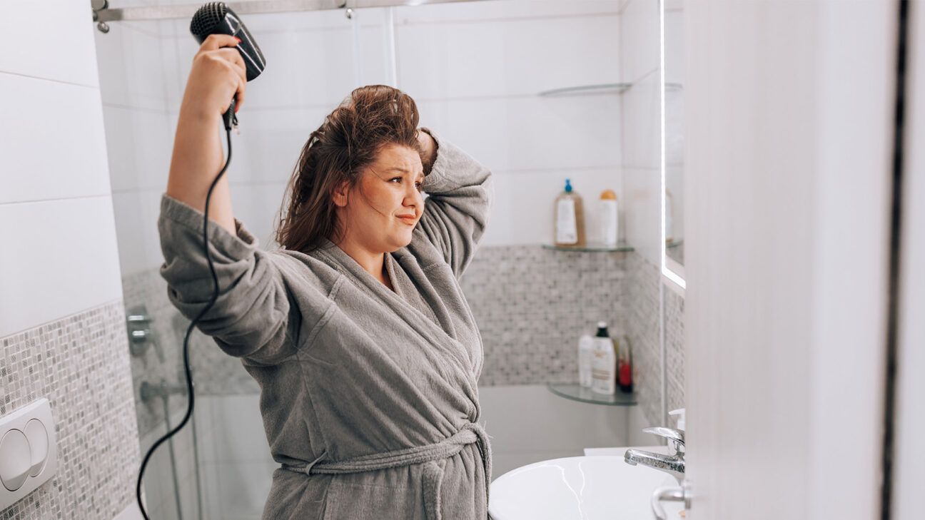 A woman drying her hair.