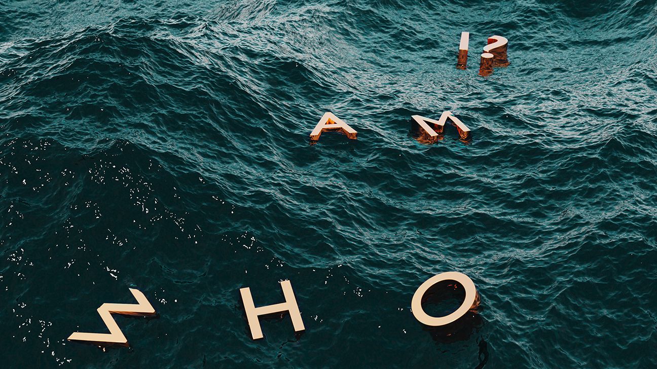 A photo of letters in the water that spell out the existential question: "Who am I?". 