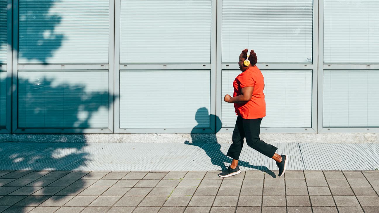 A person wearing headphones while running.