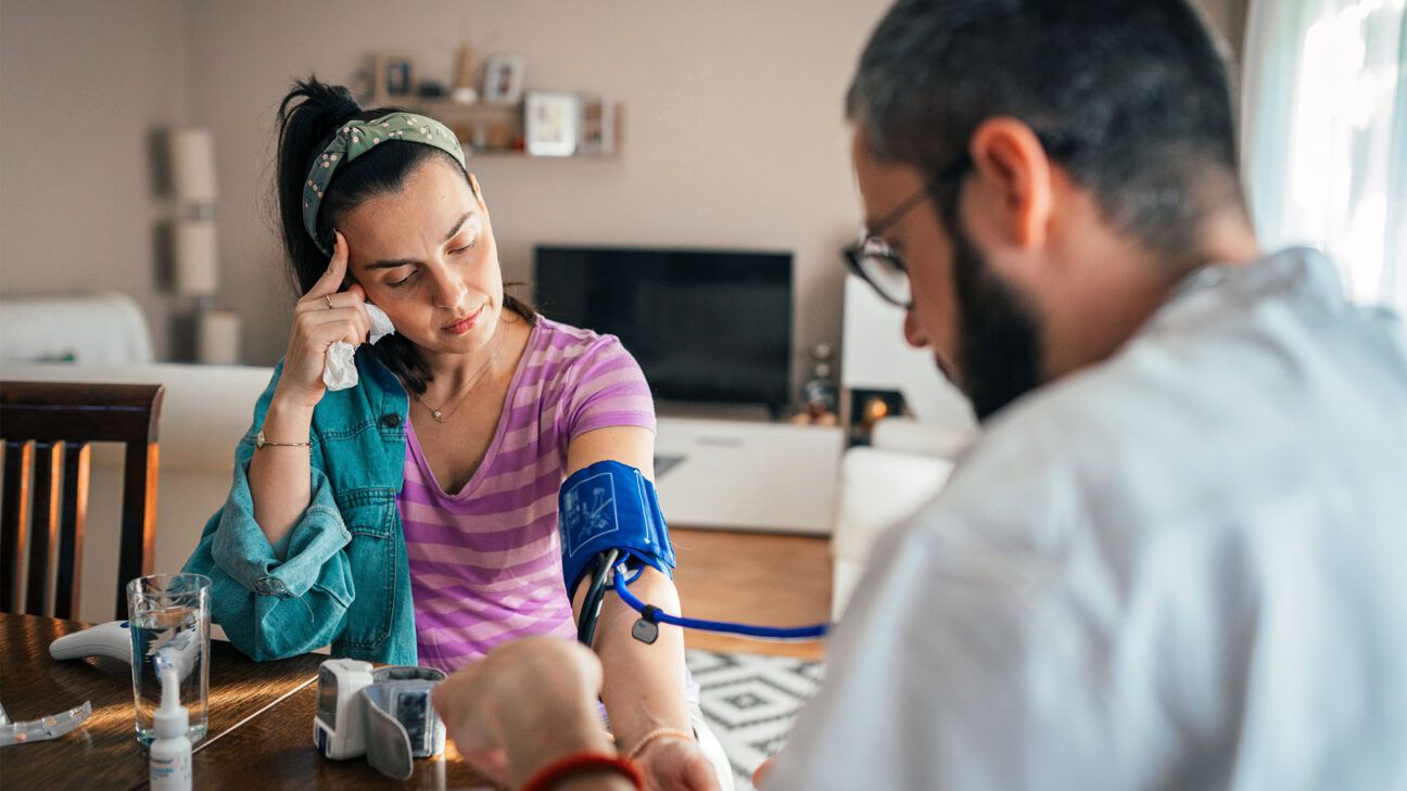 A young woman is checking her blood pressure.