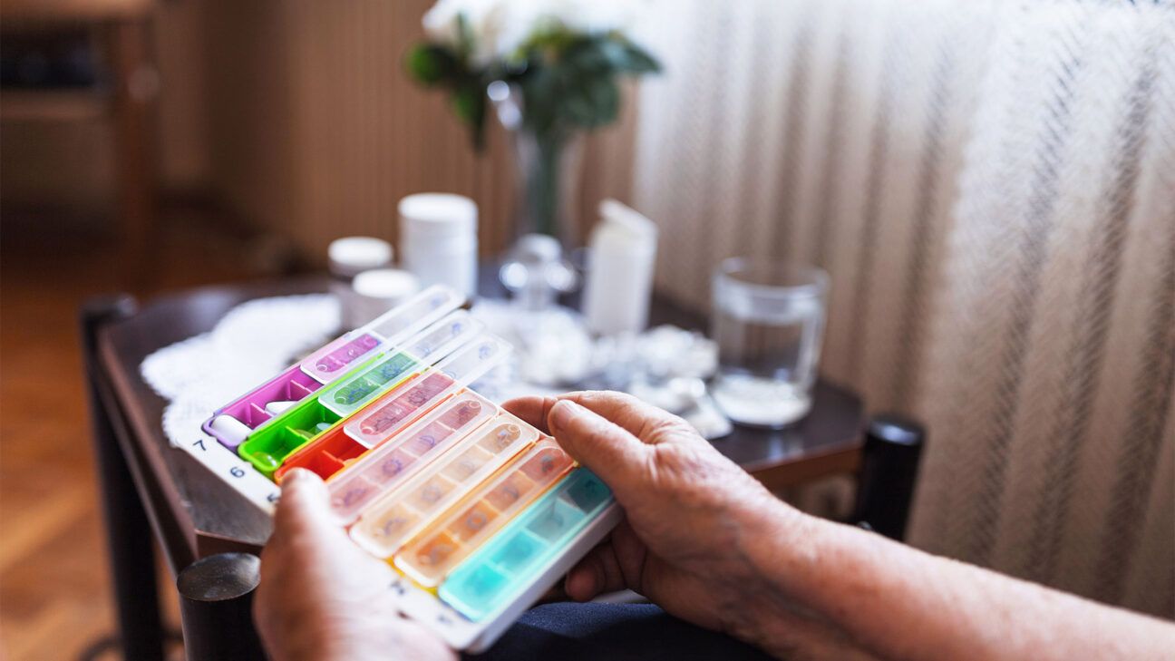 A person holding a pill box.