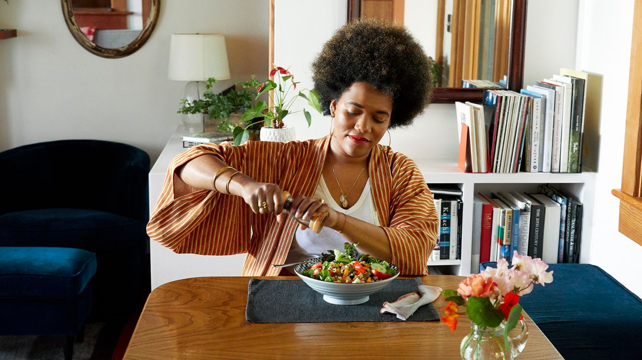 Woman eating a salad at home.