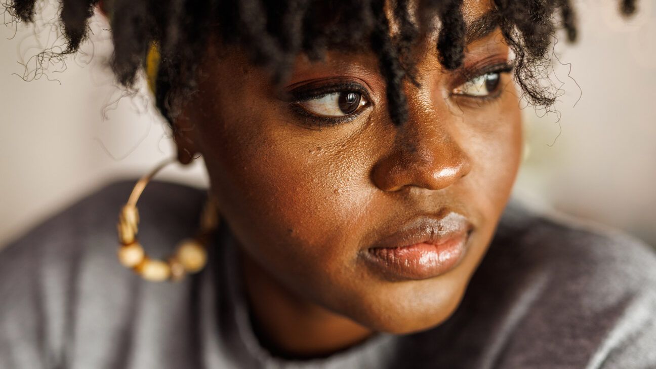 Portrait of a Black woman wearing earrings.