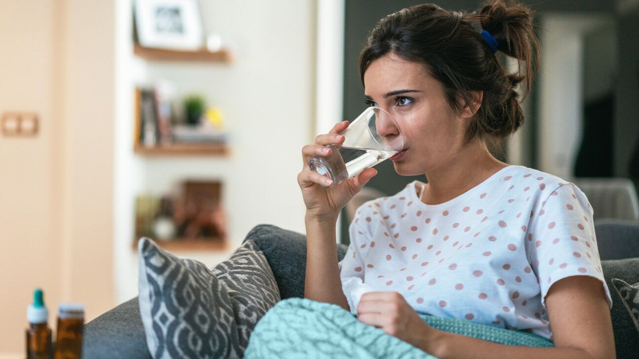 A woman drinking water.