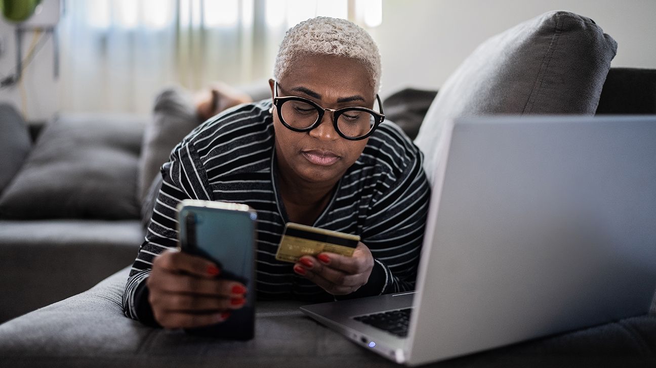 person looking at phone and computer