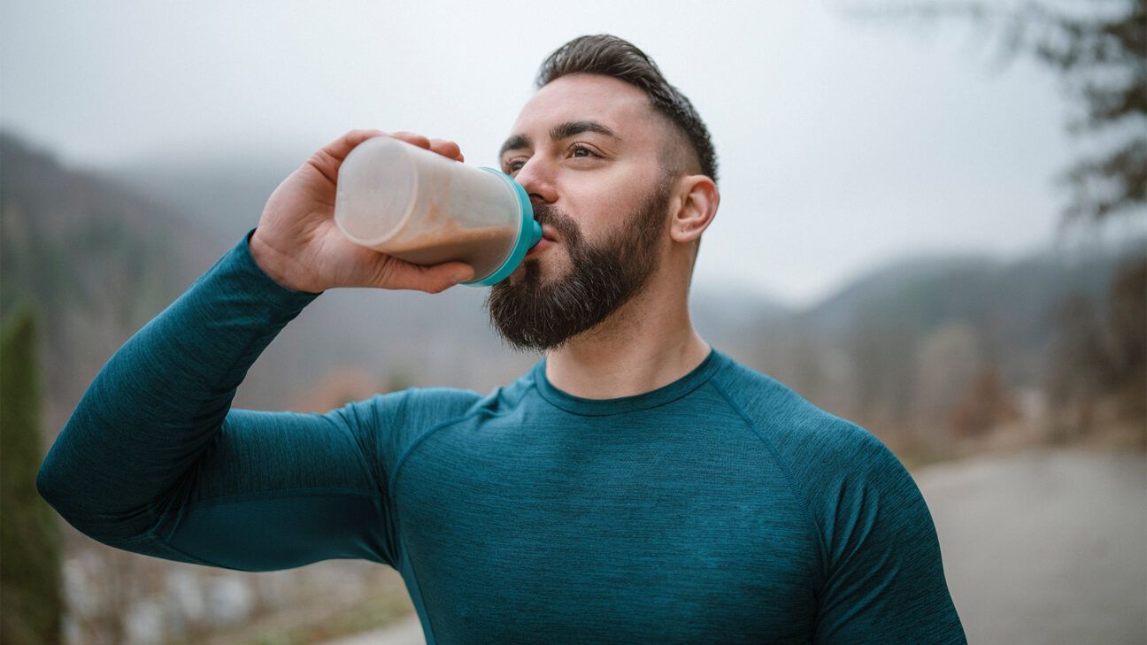 A man drinking a protein shake.
