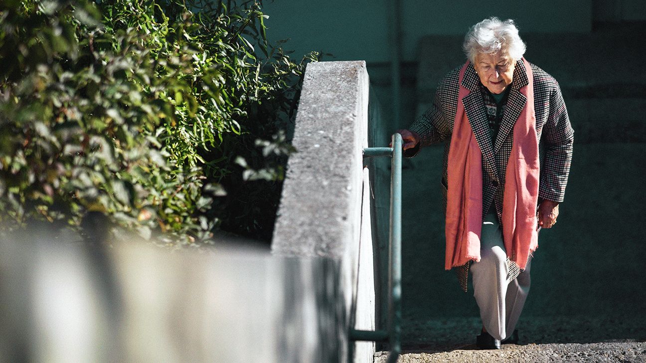 Older woman climbing stairs as osteoporosis exercise