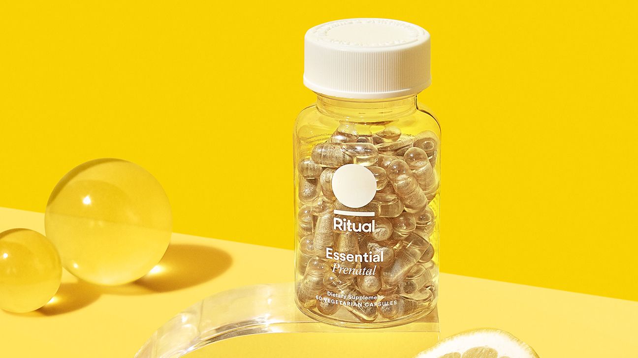 A bottle showing Ritual prenatal vitamins and a sliced lemon