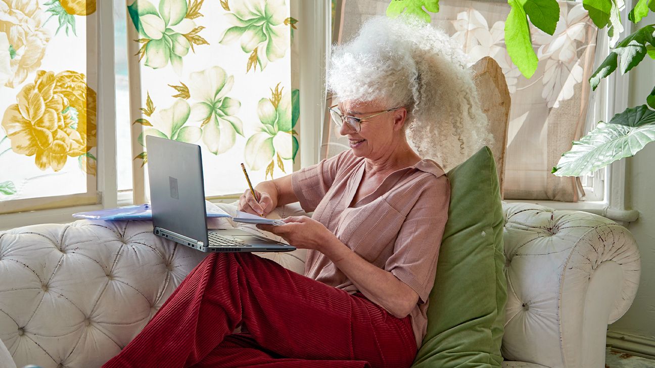 Woman using a laptop for online therapy at home