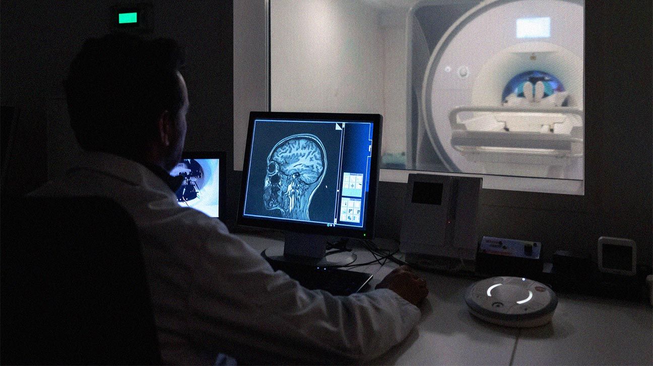 Radiologist looks at screen of MRI.