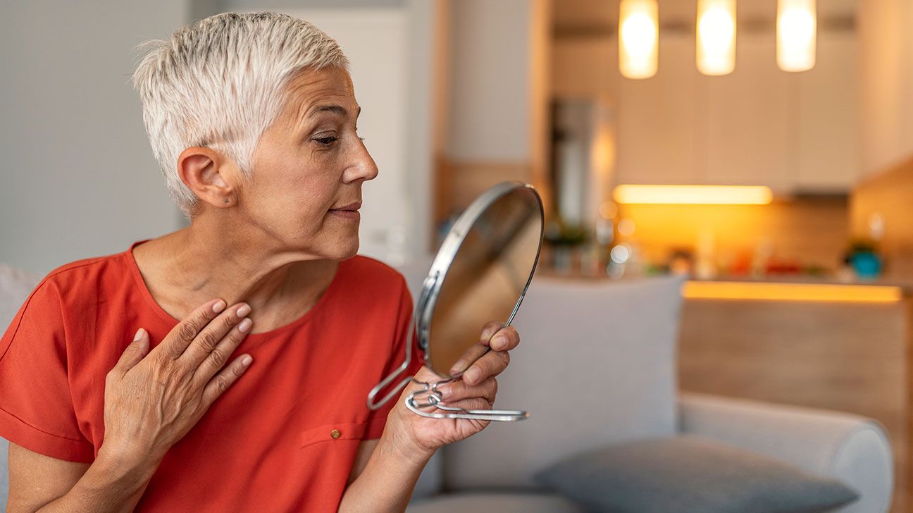 Mature woman checking for new spots that may be amelanotic melanoma